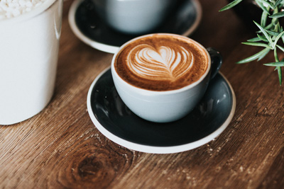 lattes on wooden table with plants