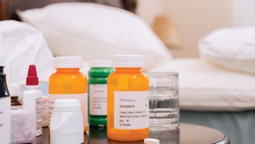 prescription bottles on a bedside table