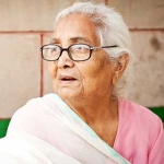 Older woman with glasses wearing a sari