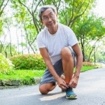 Older man tying his running shoe